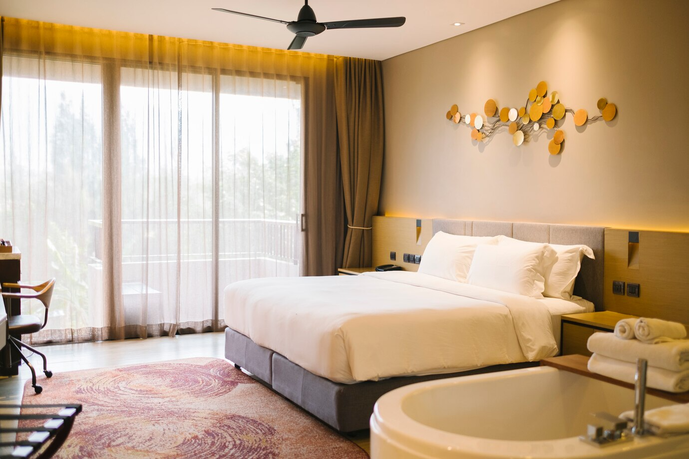 Bright hotel room with a large bed and modern decor.